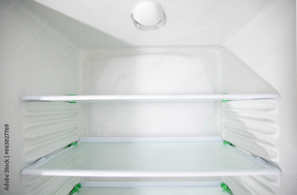 Ice and snow build up on the back wall of the refrigerator