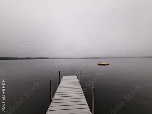 dock on a lake in morning fog