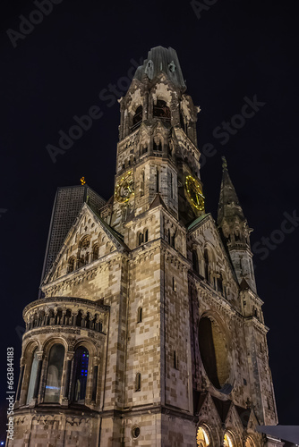 New Year's Eve night view of Kaiser Wilhelm Memorial Church with broken spire and New church and belfry on Breitscheidplatz. Berlin, Germany.