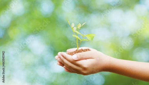 Earth Day, hands planting saplings on natural green bokeh background, forest conservation concept. and environment