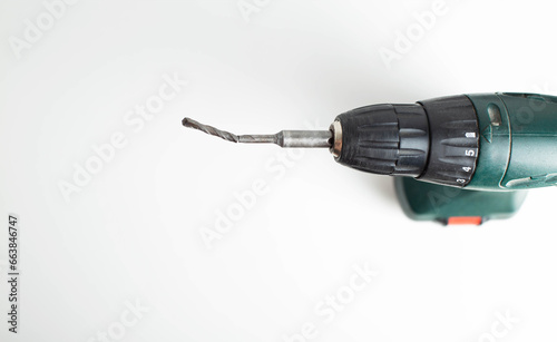 Broken low-quality drill in a screwdriver on a white background, industry photo