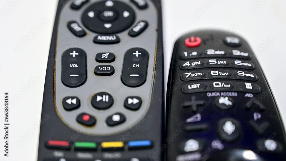 TV remote control on the table in living room. Many buttons on television remote control. TV remote control on the table in living room. Many buttons on television remote control.