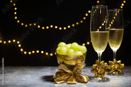 Two glasses of champagne with twelve grapes
