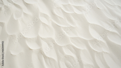 Top view of white sand, captured in close-up detail, displaying textured grains.