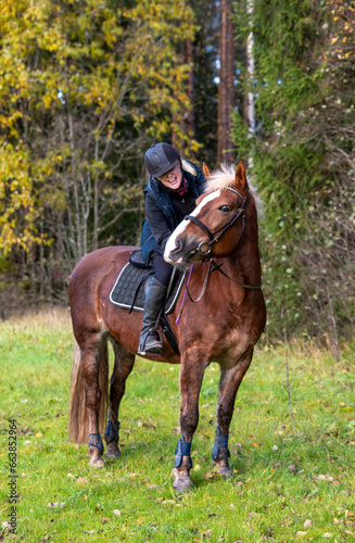 Woman horseback riding in autumn 