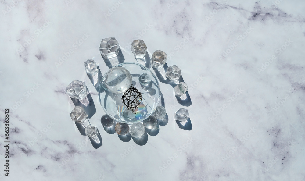 Clear quartz minerals and witch wiccan amulet with pentagram on abstract marble background. gemstones for Crystal Ritual. esoteric spiritual practice for harmony, relax. Witchcraft. flat lay Clear quartz minerals and witch wiccan amulet with pentagram on abstract marble background. gemstones for Crystal Ritual. esoteric spiritual practice for harmony, relax. Witchcraft. flat lay
