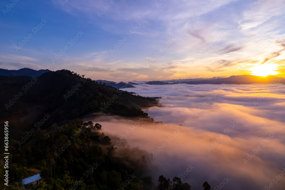 Amazing Sunrise or sunset over mountains hills covered with mist, Aerial view landscape drone shot beautiful colorful nature background