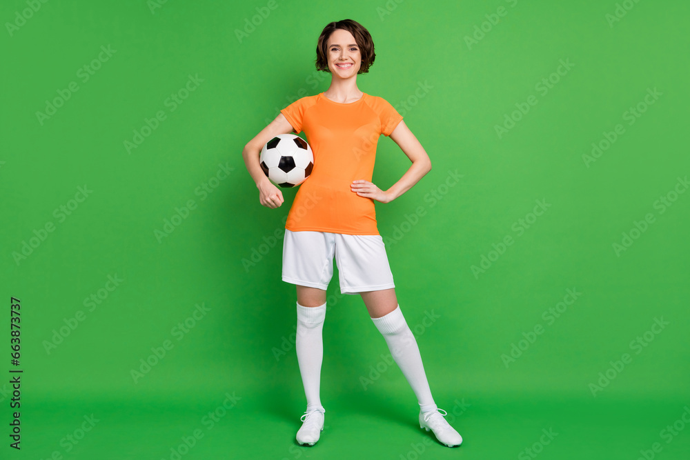 Full body portrait of charming positive lady put arm on waist toothy smile isolated on green color background