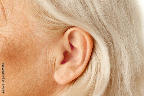 Close-up of female ear. Senior model. Hearing problems and health care, deafness, health check up. Concept of natural beauty, aging process, elderly beauty, cosmetology, skincare