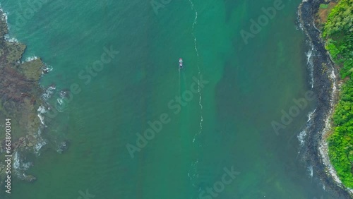 The landscape at the estuary with Vietnamese fishermen's fishing boats running out in the early morning was filmed from the air. Ocean nature and ships.
