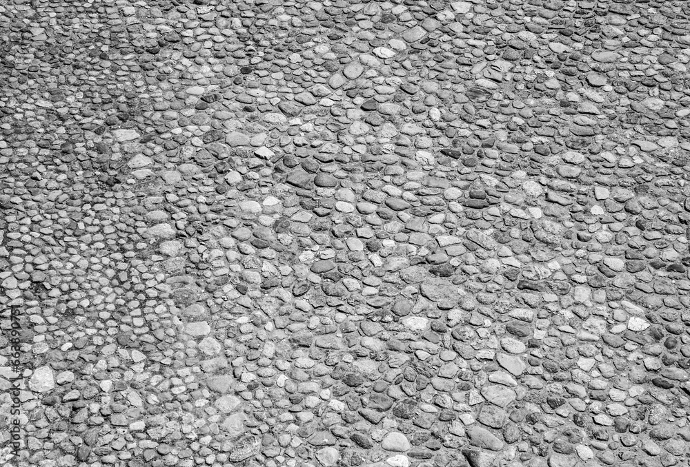 An old stone wall texture, black and white stone pattern surface background An old stone wall texture, black and white stone pattern surface background