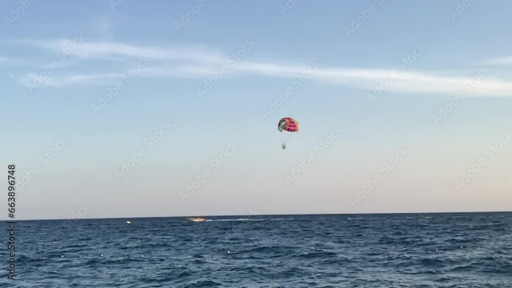 A paraglider flies over the sea. Slow motion. A paraglider flies over the sea. Slow motion.