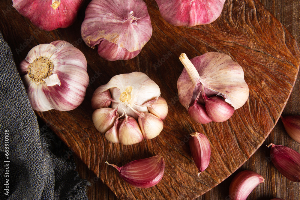 Closeup Garlic clove and bulb on wooden background top view Closeup Garlic clove and bulb on wooden background top view