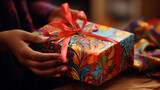 Close up portrait of beautiful female pair of hands wrapping, preparing, giving a vibrant colour wrapped gift,