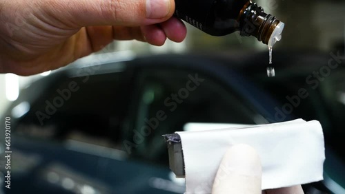 Staff wear Chemical protective clothing at work. Automobile industry. Car wash and coating business with ceramic coating.Spraying the varnish to the car. Concept of: Car protective, Service, Shine.	