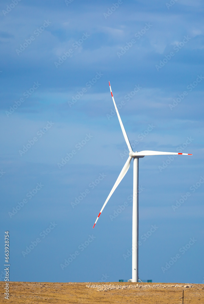 Fleet of power generators in motion. The blades of the wind farm rotate against the sky. The concept of extracting electricity from renewable sources. Wind turbine to generate electricity. Fleet of power generators in motion. The blades of the wind farm rotate against the sky. The concept of extracting electricity from renewable sources. Wind turbine to generate electricity.