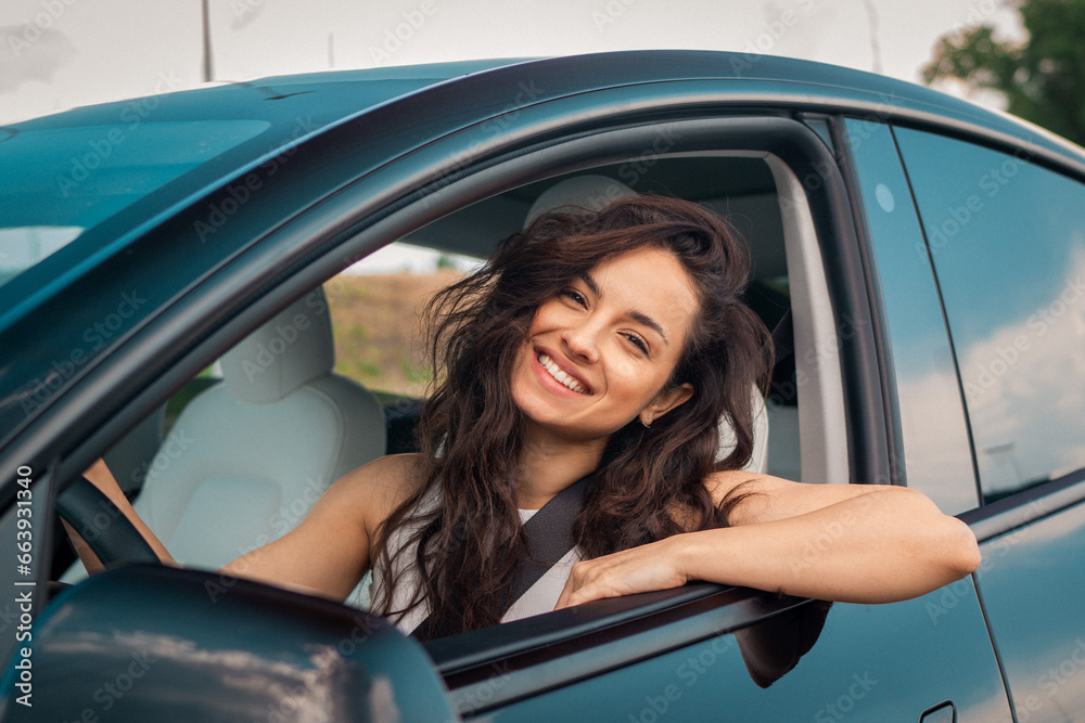 Smiling Caucasian lady on road, enjoying window view and traveling on holiday road trip. Travel, lifestyle, transport concept