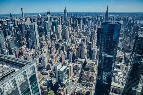 Принти на полотні An aerial view of the rooftops of buildings and bustling streets of New York