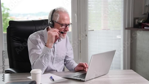 Senior businessman with headset having online conference