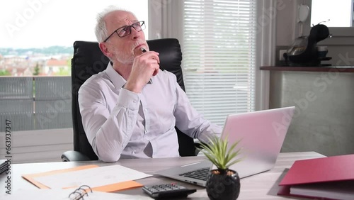 Portrait of thoughtful businessman sitting at office