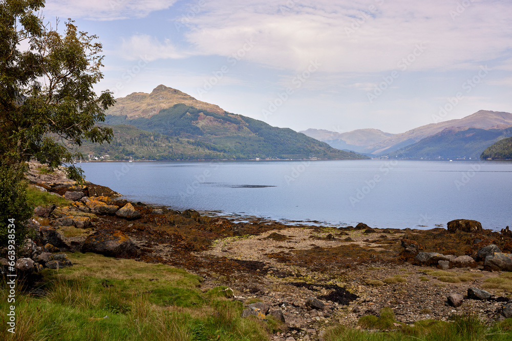 From across Loch Goil, a distant view of Carrick Castle with hazy hills in the background