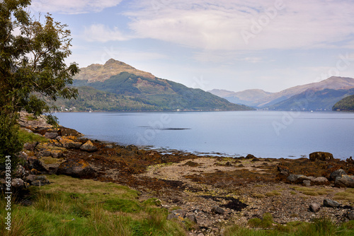 From across Loch Goil, a distant view of Carrick Castle with hazy hills in the background