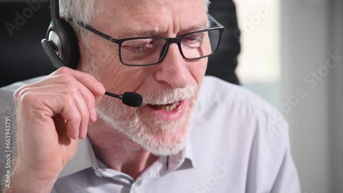 Senior businessman with headset having online conference
