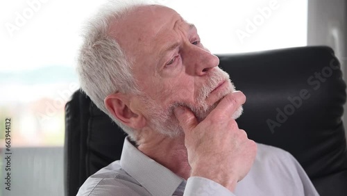 Portrait of thoughtful businessman sitting at office