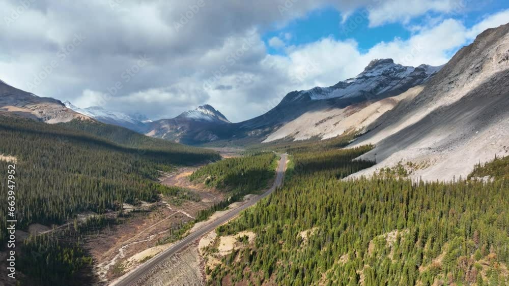 The road in the mountain valley. Traveling by car. Landscape from the air. Video for background. Fall view. Mountains and forest. Natural landscape. The road in the mountain valley. Traveling by car. Landscape from the air. Video for background. Fall view. Mountains and forest. Natural landscape.