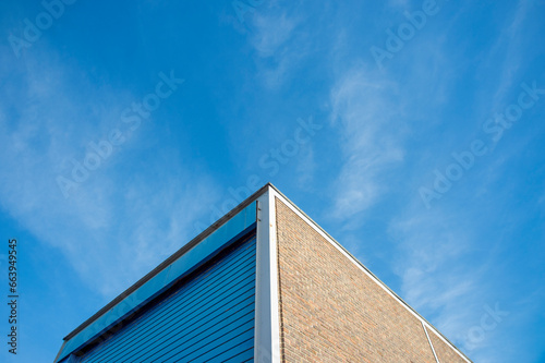 industrial estate construction warehouse unit with roller door against a blue sky