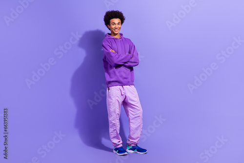 Full size photo of positive nice young person good mood crossed arms posing isolated on violet color background © deagreez