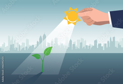 Photosynthesis.Hand holding a sun to illuminate seedling.Investment, prosperity and economic growth or saving and business profit concept.