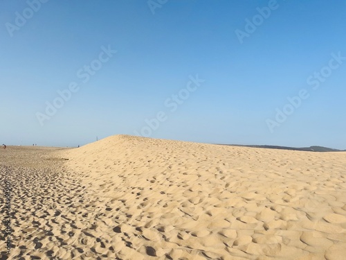 Sandy ocean dunes and blue sky