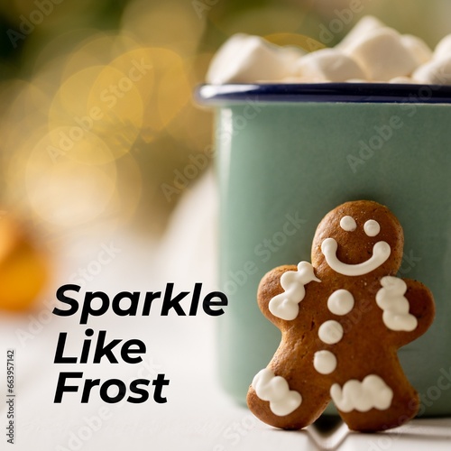 Composite of sparkle like frost text over gingerbread man and cup of hot chocolate