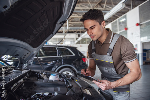 Handsome auto service worker