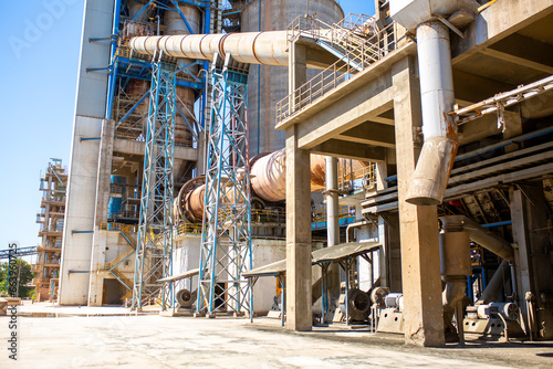 Cement factory. Pipes and compressors, equipment, metalurgy. Modern technologies work at a cement plant. Technological work on the production of cement. Working atmosphere with copy space.