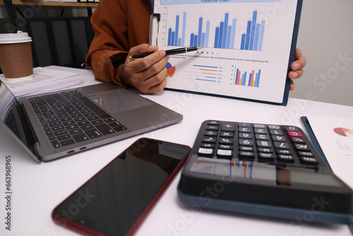 A businessman is presenting a quarterly annual business income graph in the office.
