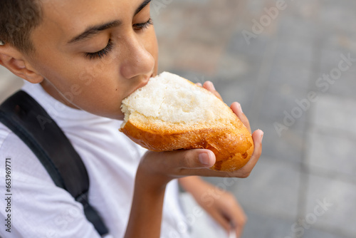 Delightful kid enjoying a sugary milk bun
