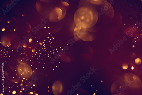 Golden abstract bokeh on black background. Celebrating Christmas, New Year or other holidays.