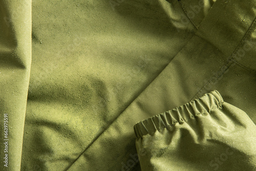Close-up of a jacket made of membrane fabric in raindrops. Tourist clothing for any weather.