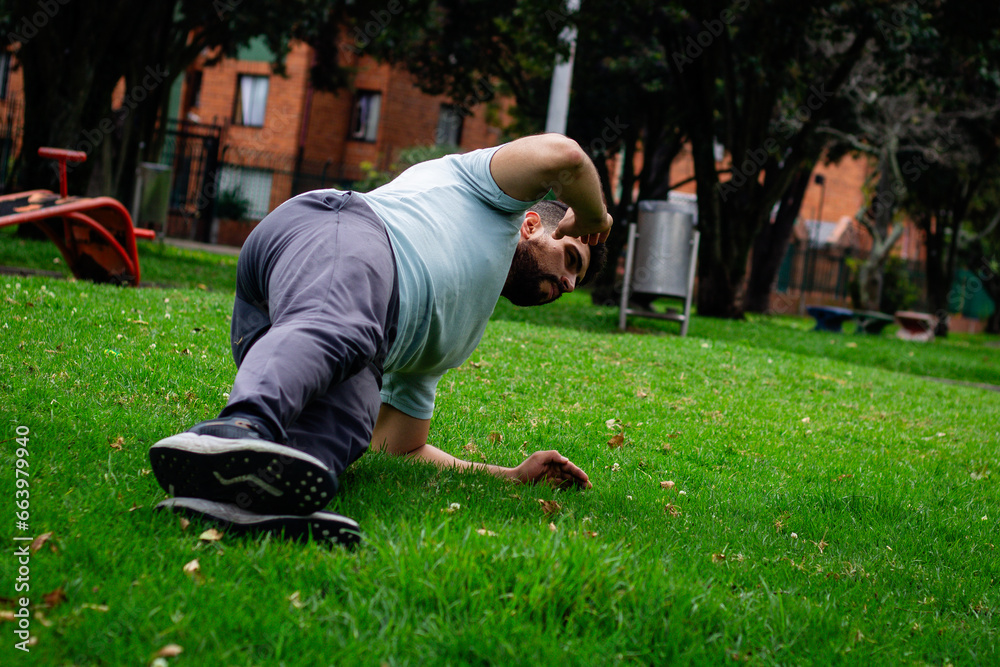 young man doing abdominal exercise in a park in the city young man doing abdominal exercise in a park in the city