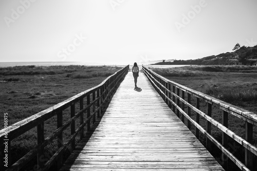 Landscape with black and white unrecognizable person on the beach. Concept: lifestyle, freedom, landscape