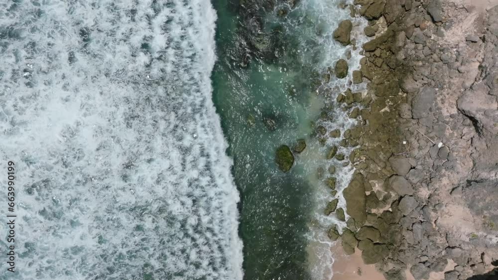 Cliff aerial top down view of a rocky coastline in Uluwatu, Bali. Cliff aerial top down view of a rocky coastline in Uluwatu, Bali.