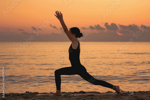  young girl practicing yoga at the beach at sunrise