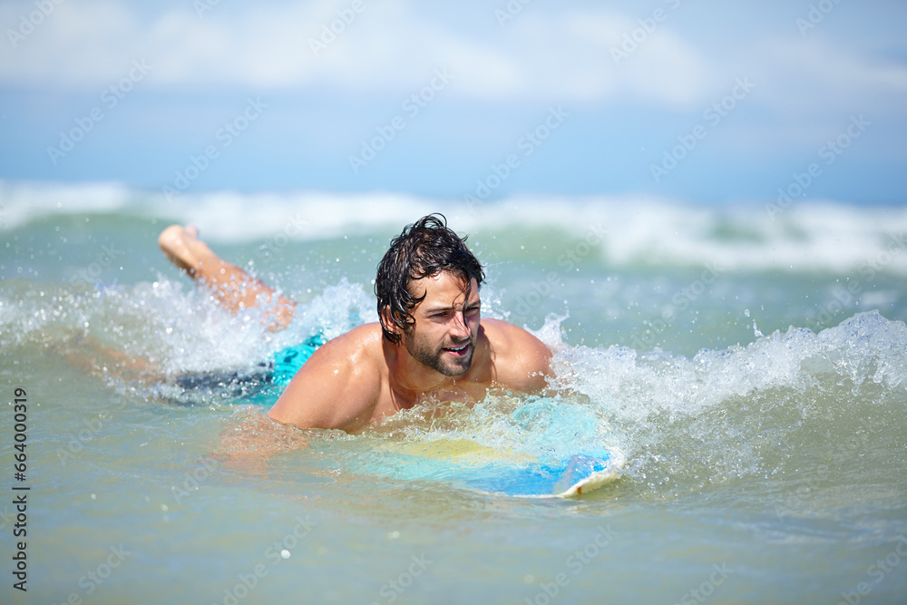 Man, surfing and sea swimming with workout, training and waves with water sport and exercise outdoor of athlete. Surfer, freedom and vacation by the ocean and beach for summer wellness and fitness
