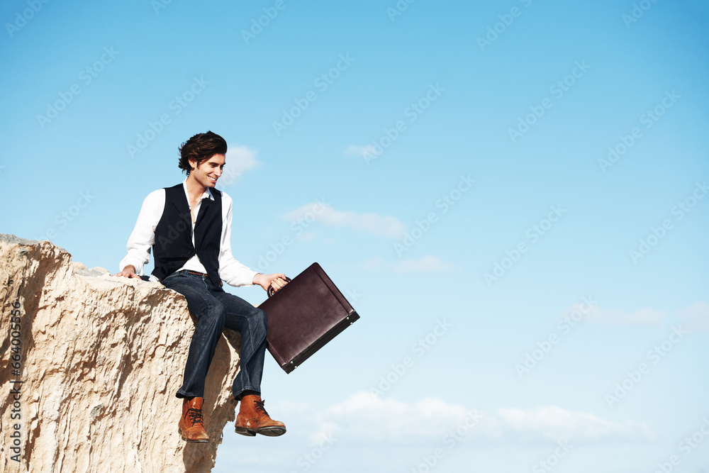 Blue sky, cliff and business man sitting for freedom, holiday and vacation to relax in nature. Professional, banner and corporate worker on rocks with briefcase for mindset, break and happiness Blue sky, cliff and business man sitting for freedom, holiday and vacation to relax in nature. Professional, banner and corporate worker on rocks with briefcase for mindset, break and happiness