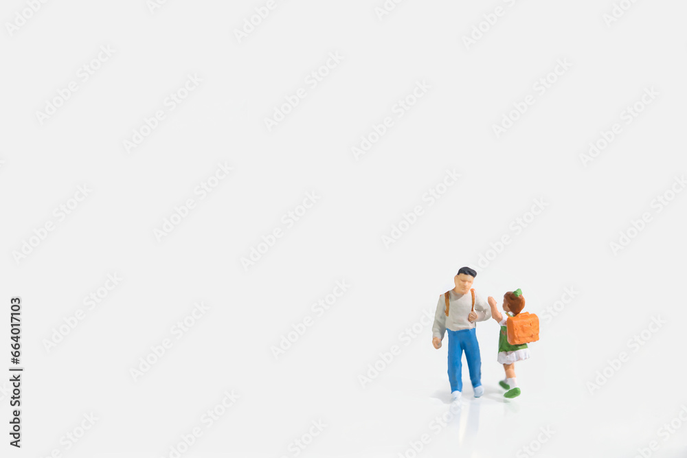 School children with schoolbags, miniature figures scene, white background, copy space