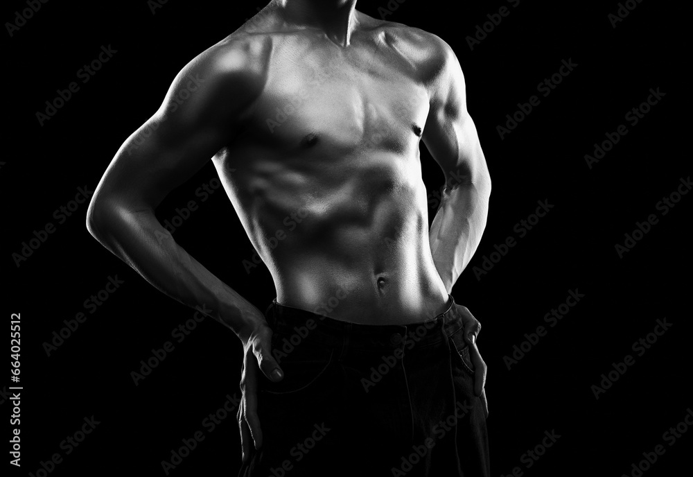 Silhouette of a slender muscular man doing sports in the gym. Sports and healthy lifestyle. - obrazy, fototapety, plakaty 