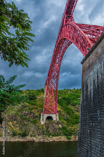 Garabit Viaduct, a red railway arch bridge constructed by Gustave Eiffel. Cantal, France photo