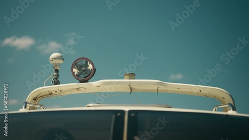 Lamp and sound signal device on hardtop of modern motor boat under clear sky closeup. Upper parts of sailboat on sunny day. Yacht equipment